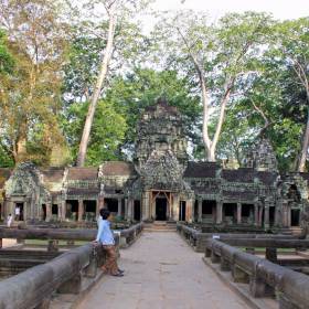 Храм Та-Пром, Ангкор, Камбоджа Храм Та Пром, как и Ангкор Ват, занимает большую территорию, но по архитектуре совершенно не похож на другие храмы Ангкора. Он состоит из цепочки одноэтажных длинных строений, соединенных между собой сквозными проходами и галереями. Та Пром обнесен внушительной стеной, но она не отделяет его от джунглей. Огромные деревья с лианами растут прямо среди зданий, обволакивая их своими мощными корнями, прорастают сквозь стены, разорвав камни. - Путешествие  по Камбодже, декабрь 2012г.
