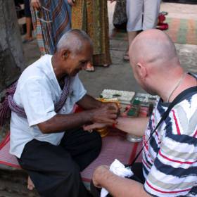Монах с молитвой повязывает нам охранные обереги - Путешествие группы МироТворцев по Камбодже, декабрь 2012г.